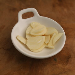 Garlic in a plate on white background