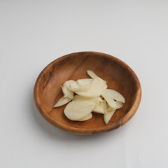 Garlic in a plate on white background