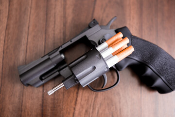 Cigarettes attached to a gun and loaded into a gun