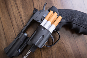 Cigarettes attached to a gun and loaded into a gun