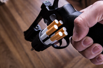 Cigarettes attached to a gun and loaded into a gun
