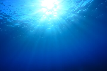 Fototapeta premium Sunlight Beams Through Deep Blue Ocean in Serene Underwater Scene with Vibrant Marine Colors and Natural Light.