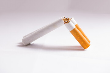 Burning cigarette with smoke and concept of cigarettes as a shotgun rifle 