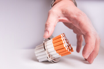 Cigarettes attached to a handcuff and hand, as in attached to your self and cant quit
