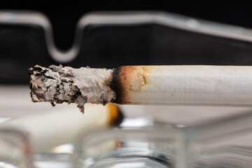 Burning cigarette with smoke and concept of cigarettes 