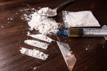 Concept of cocaine and other drugs on a table for an addict