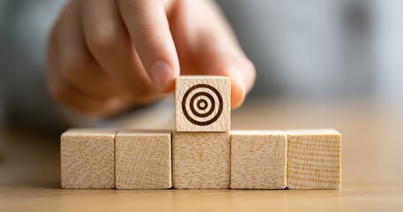 Hand placing a target block with focus.