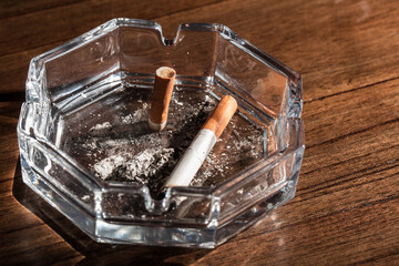 Burning cigarette with smoke and concept of cigarettes 