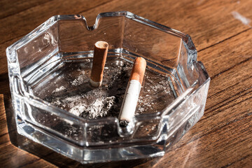 Burning cigarette with smoke and concept of cigarettes 