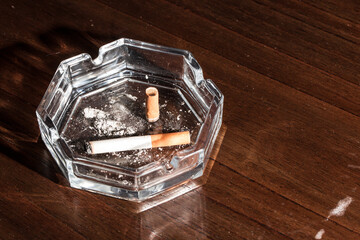 Burning cigarette with smoke and concept of cigarettes 