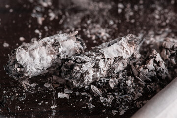 Burning cigarette with smoke and concept of cigarettes 