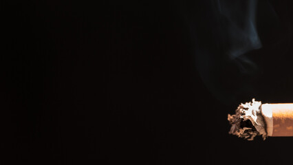 Burning cigarette with smoke and concept of cigarettes 