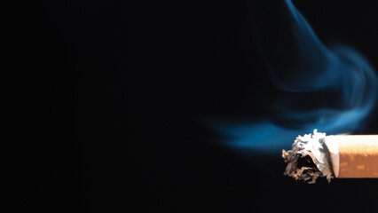 Burning cigarette with smoke and concept of cigarettes 
