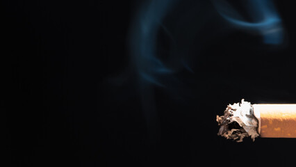 Burning cigarette with smoke and concept of cigarettes 