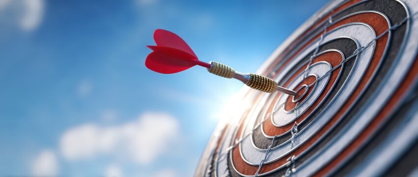 Red dart perfectly hits the bullseye on a dartboard.