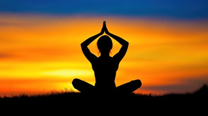 Silhouette of a person meditating at sunset.