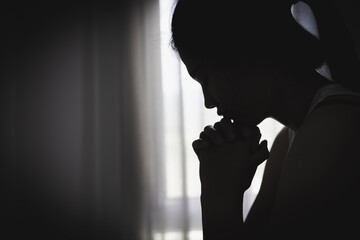 Sad and depressed woman sitting on sofa at home.Stop violence against women,  Domestic abuse victim. Suicide due to depression.