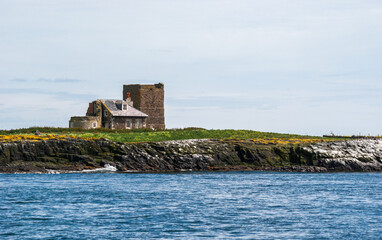 Keeper's cottage and remains of the two lighthouse towers on Brownsman Island in the Farne Islands, Northumberlandshire - UK