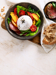 Salad with burrata cheese, lettuce and tomatoes