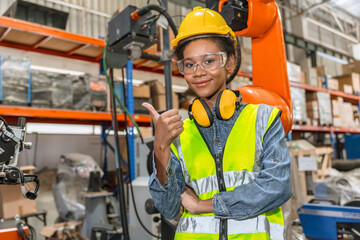 professional young engineer, technician work in modern factory industrial robot welding arm machine control operator