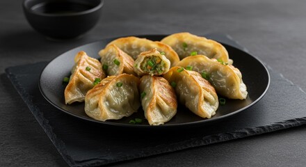 Photo of Delicious Fried Dumplings on Plate with Black Background