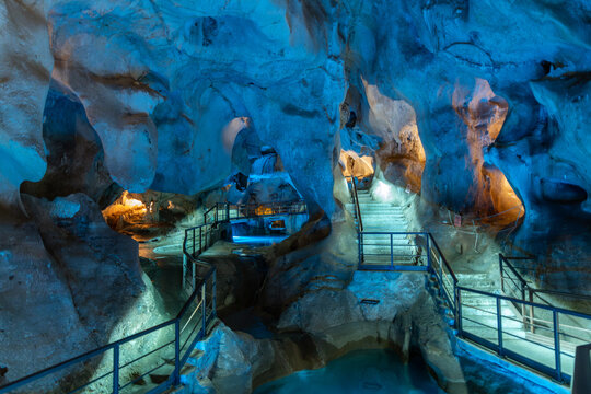 Cueva del Tesoro. Stunning cave interior with illuminated rock formations and pathways, showcasing natural beauty and unique geological features in a serene environment