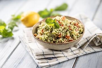 Traditional Tabouleh salad with bulgur, parsley, cucumber, tomato, coriander, garlic, mint and other ingredients