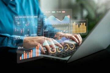 Businesswoman analyzing digital financial data and chart reports on virtual interface with laptop for stock trading, business growth, financial technology and digital marketing strategy concept