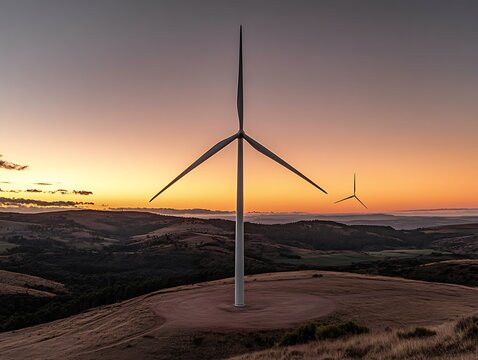 Wind Turbines Silhouetted Against a Gradient Orange Sky at Sunset - Powered by Adobe