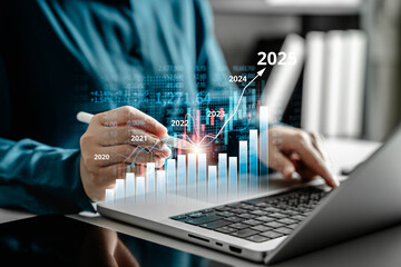 Businesswoman analyzing virtual stock market graph on laptop, financial data and trading interface in modern technology environment, fintech, business intelligence and economic investment concept.