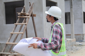 Asian young foremen worker male looking at camera on construction site wear white helmet and safety vest, architect engineering man using technology laptop, Professional engineers work with confidence