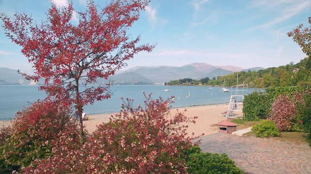 Beach on lake Maggiore, Italy. Town of Reno, known for  the presence of the famous Hermitage of Santa Caterina del Sasso. In the background the towns of Verbania, Pallanza, Feriolo and the Alps