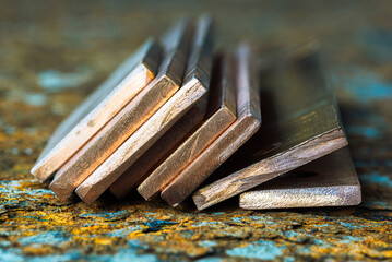 Copper ingots on a corroded steel surface, products of the metallurgical industry