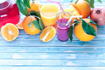 freshly squeezed orange and pomegranate juices with oranges and pomegranate fruit