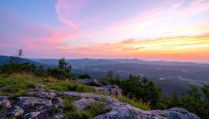 Obraz premium Mountain top vista under a colorful dawn sky with rolling hills