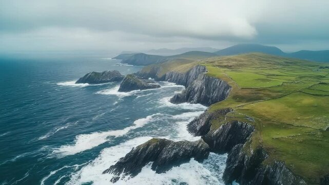 Aerial View of Dramatic Cliffs and Coastal Scenery of Dingle Peninsula, Ireland, with Crashing Waves and Green Fields on a Cloudy Day