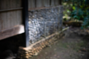 Abstract blurred view of a traditional house foundation made of stone and wood, creating a moody...