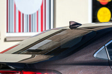 Car parked near a colorful mural on a sunny day in an urban setting © ako-photography