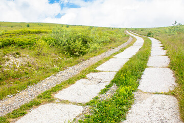 old concrete mountain road. path through smooth mount on a cloudy day. travel ukraine. carpathian landscape