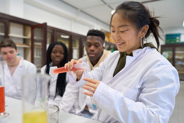 Young students doing chemical experiments in laboratory
