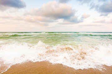 wave washing the sandy beach. summer vacation. cloudy weather. scenery at the black sea in evening light. beautiful view