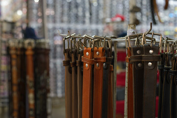 Group of handmade leather belts at a street market. Selective focus