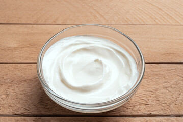 Bowl of Greek Yogurt on wooden background