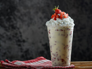 Delicious Strawberry Cream Drink in a Plastic Cup, decorated with strawberries