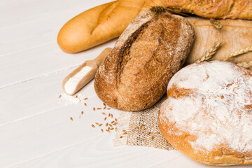 Homemade natural breads. Different kinds of fresh bread as background, perspective view with copy space