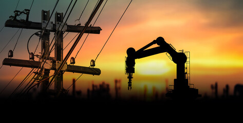 Tower electric poles and mechanical arms caught in sunset light across an industrial skyline, illustrating innovation in energy automation and the evolution of urban tech environments.