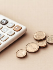 Calculating Finances: A crisp, top-down shot of a calculator with coins and a light background creates a strong visual for finance and business themes.
