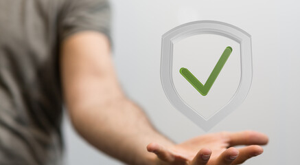 Image of a hand holding a digital shield with a checkmark, symbolizing data security and protection.
