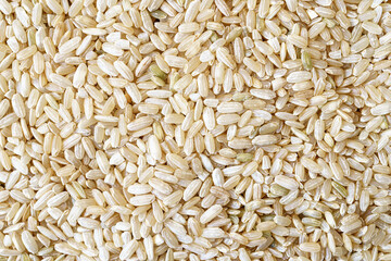 Full frame close up flat lay texture of brown rice for food and nutrition background healthy eating and cooking concept with copy space pattern of organic grains.