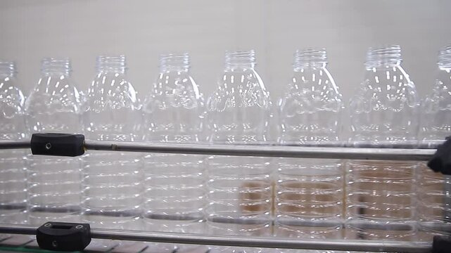 Automated plastic bottle for milk, production line showcasing assembly, alignment, and quality control.
